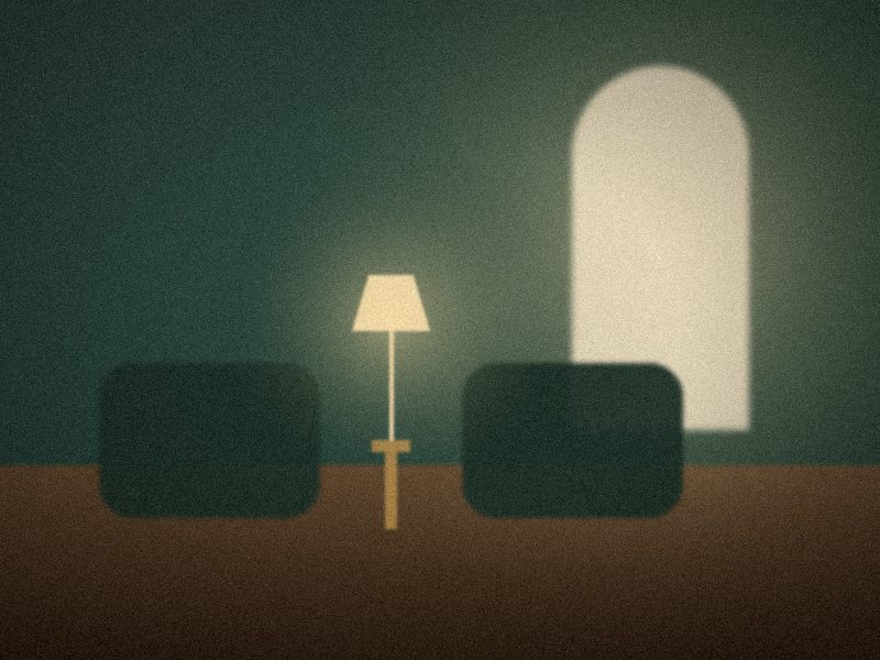 Petit salon feutré avec deux fauteuils face à face et une lampe allumée